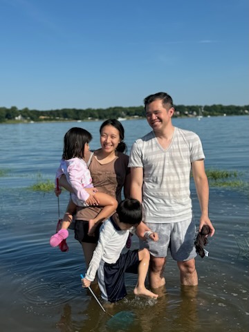 Dr. Low in the water with his wife and children