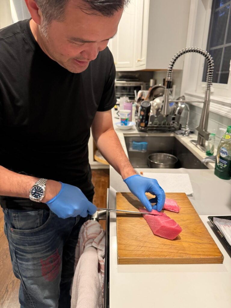Dr. Low preparing fish at home