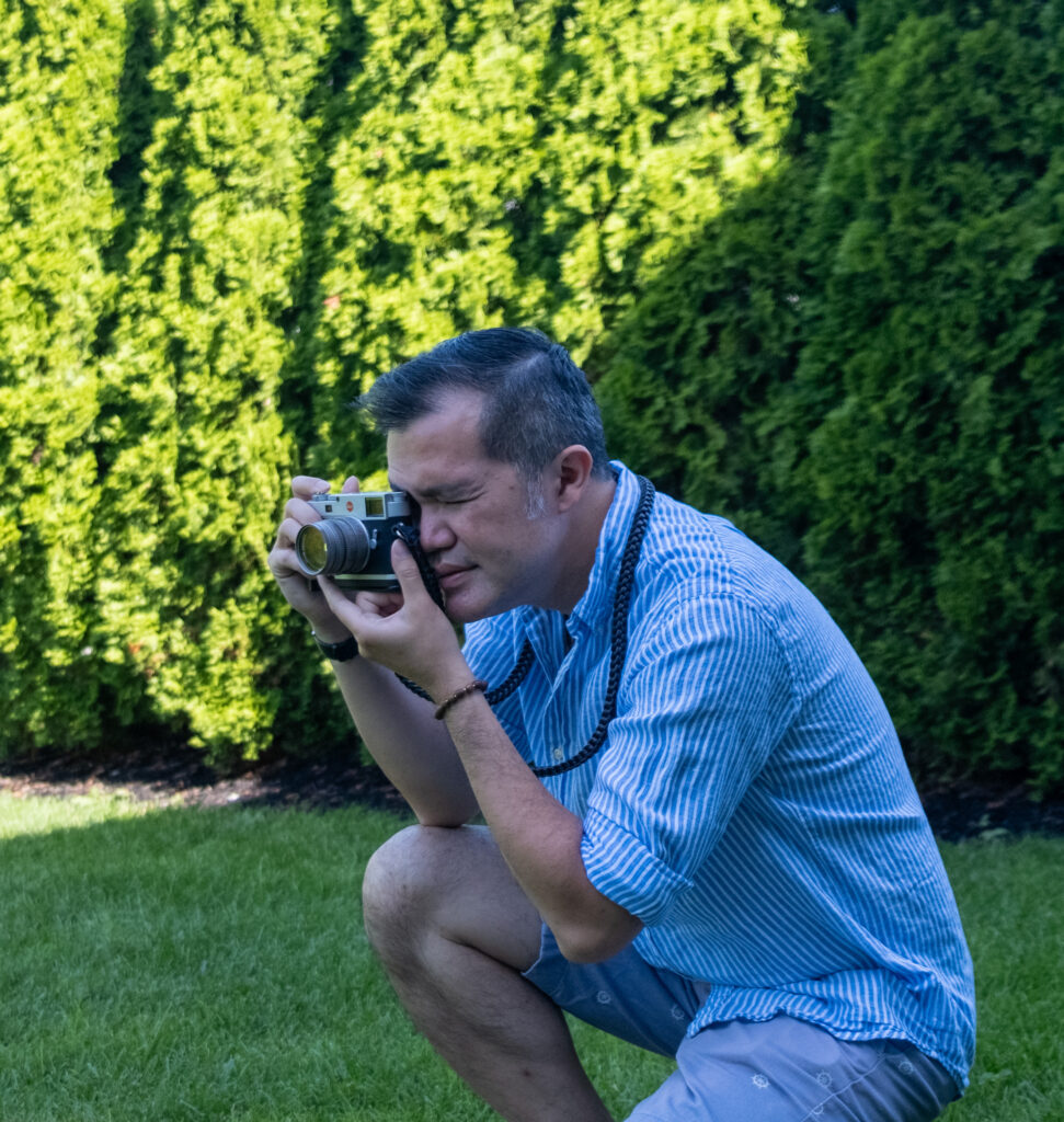 Dr. Low photographing with his rangefinder camera